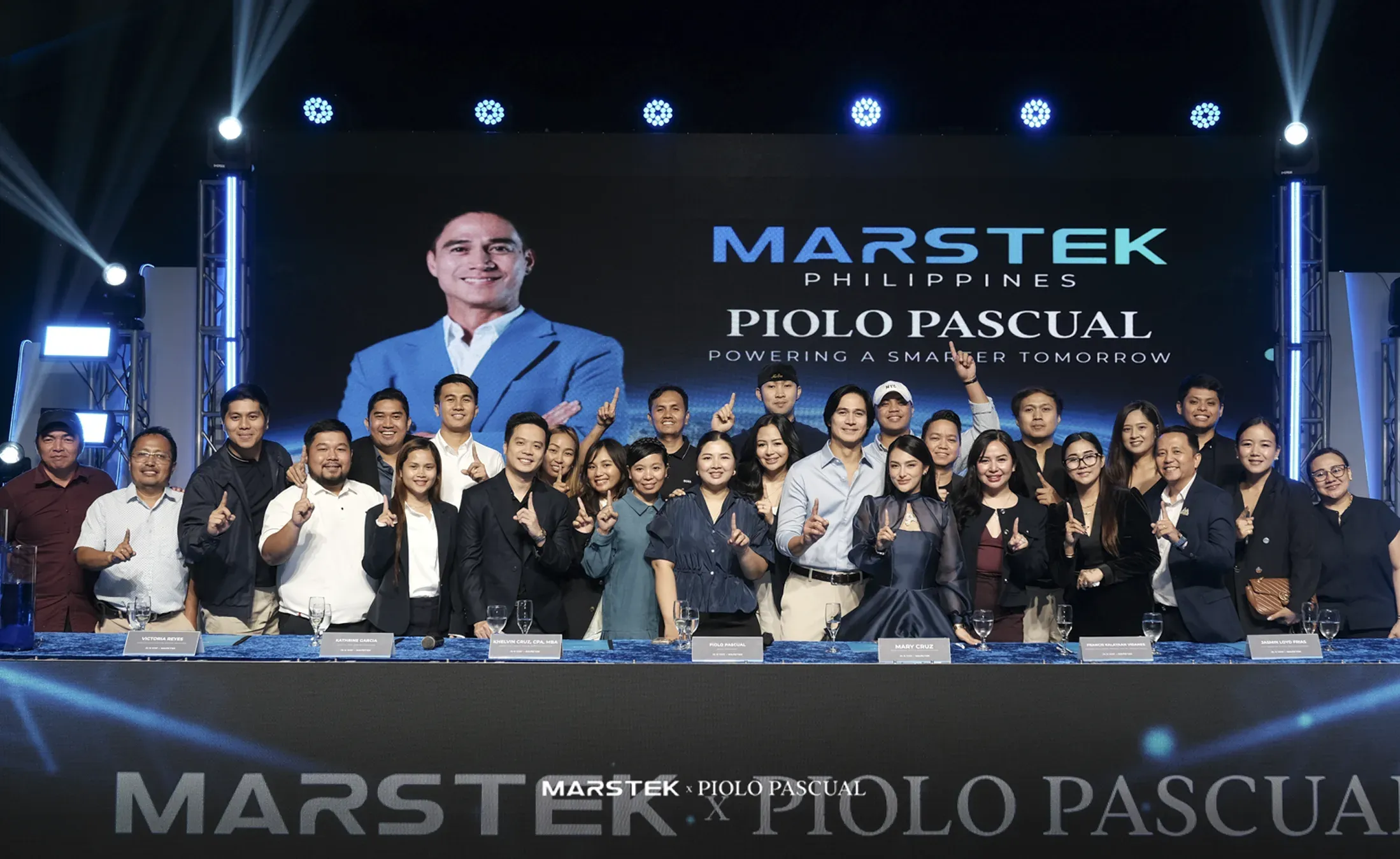 The MARSTEK Philippines team and partners with Piolo Pascual at the signing table of the MARSTEK × Piolo Pascual event, under a screen reading 'MARSTEK Philippines, Piolo Pascual, Powering a smarter tomorrow'.